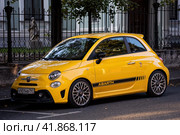 Fiat 500 Abarth parked in the street. Yellow small popular city car. Редакционное фото, фотограф Константин Григорьев / Фотобанк Лори