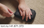 Close-up of a woman's hands opening a case with a glucometer and a container of blood test strips. The blood sugar test. Krasnodar, Russia, April 19, 2022. Редакционное видео, видеограф Воловодов Владимир / Фотобанк Лори
