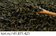 Black Dry Tea Wallpaper. Wooden spoon picks up Mix Black and Green Tea Leaves. Close Up, Macro. Top View. Texture. Copy Space. Dried Tea is Spinning, Rotating on Turntable. Food and Drink Background. Стоковое видео, видеограф Марина Демидюк / Фотобанк Лори