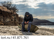 man is sitting aboard a broken boat. Стоковое фото, фотограф Артем Курутин / Фотобанк Лори
