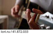 Playing the guitar. Strumming acoustic guitar. Musician plays music. Man fingers holding mediator. Man hand playing guitar neck in dark room. Unrecognizable person rehearsing, fretboard close-up. Стоковое видео, видеограф Марина Демидюк / Фотобанк Лори