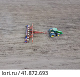 Sowing of corn. Tractor with a seeder on the field. Using a seeder for planting corn. Стоковое фото, фотограф Леонид Еремейчук / Фотобанк Лори