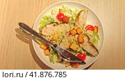 Chicken Salad. Traditional Chicken Caesar Salad in a white plate on wood Table Served in a Cafe or a Restaurant. Fresh Caesar Salad with grilled chicken breast, fresh green leaves, Cheese and Croutons. Стоковое видео, видеограф Марина Демидюк / Фотобанк Лори