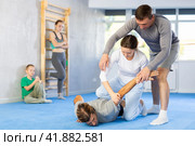 Woman student, with help of male teacher, completes neutralization of opponent. Стоковое фото, фотограф Яков Филимонов / Фотобанк Лори