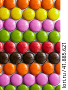 Сolored milk chocolate folded in colored rows. Close-up of sweets. Vertical wallpaper. Selective focus. Стоковое фото, фотограф Клара Мухаметзянова / Фотобанк Лори