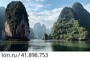 Beautiful landscape of tropical coast with karst limestone islets and cliffs. Стоковое AI-изображение, AI-художник Евгений Харитонов / Фотобанк Лори