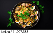 Spaghetti alle vongole with tomato in seafood jus served as close-up at a Nordic design bowl with copy space. Стоковое AI-изображение, AI-художник Ирина Ручушкина / Фотобанк Лори