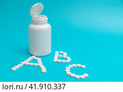 White tablets near the pharmacy jar in the shape of the letters ABC. Стоковое фото, фотограф Ярославский Максим / Фотобанк Лори