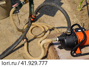 Self-priming garden pump and hose system connected to it. Стоковое фото, фотограф Леонид Еремейчук / Фотобанк Лори