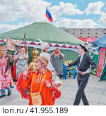 Senior woman in traditional festive clothes of Mansi people dancing. Traditional Irbit fair, Russia (2023 год). Редакционное фото, фотограф Ирина Кононова / Фотобанк Лори