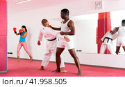 Men perform strength techniques and grabs at self-defense training in sports club. Стоковое фото, фотограф Яков Филимонов / Фотобанк Лори