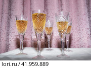 Five crystal glasses with champagne on a curtain background, nineties style concept. Стоковое фото, фотограф Сергей Чайко / Фотобанк Лори