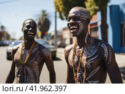 African aborigines with painted faces dance in a modern city. Стоковое AI-изображение, AI-художник Irina Kuchugurina/Gaudy / Фотобанк Лори