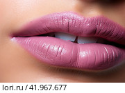 The lip of a young woman with pink lipstick. Very close-up. The concept of luxury cosmetics. Стоковое AI-изображение, AI-художник Ярославский Максим / Фотобанк Лори