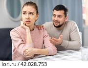 Apologetic husband calming upset wife after spat at home. Стоковое фото, фотограф Яков Филимонов / Фотобанк Лори