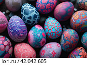 Background of Easter colored blue and purple eggs with abstract patterns. Стоковое AI-изображение, AI-художник Ярославский Максим / Фотобанк Лори