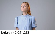 Young woman with clenched fist fighting for change, justice on gray background. Стоковое видео, видеограф Сергей Толмачёв / Фотобанк Лори