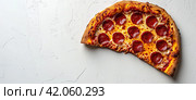 A large slice of pizza with sausage lies on a white background. A banner to advertise a pizzeria. Стоковое AI-изображение, AI-художник Ярославский Максим / Фотобанк Лори