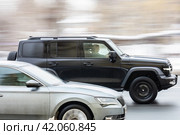 Great wall tank 300 car is driving in the cityscape. Side view of black chinese SUV in motion. Редакционное фото, фотограф Константин Григорьев / Фотобанк Лори
