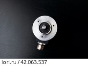Metal encoder on a black wooden table. Стоковое фото, фотограф Аксенова Вера / Фотобанк Лори