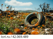 Old rusty tires are dumped among the grass. ,Generative AI. Стоковое AI-изображение, AI-художник Анна Кривицкая / Фотобанк Лори