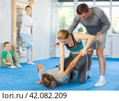 Girl student, with help of male teacher, completes neutralization of opponent. Стоковое фото, фотограф Яков Филимонов / Фотобанк Лори