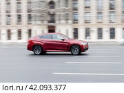 Car BMW X6 F16 moving on the street. SUV vehicle driving along sunny street in city with blurred background. Редакционное фото, фотограф Константин Григорьев / Фотобанк Лори