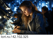 Chemical laboratory scene: attractive young PhD student scientist observing the blue indicator color shift in the glass tube. Стоковое AI-изображение, AI-художник Ирина Михайличенко / Фотобанк Лори