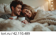 Young loving couple in the bed with cops of coffee. soft and light colors. copy space. Стоковое AI-изображение, AI-художник Юлия Гапеенко / Фотобанк Лори