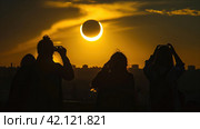 People watching a solar eclipse. Стоковое AI-изображение, AI-художник Кирилл Черезов / Фотобанк Лори