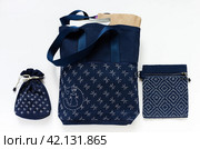 Flat lay of handmade shopping bag with Sashiko embroidery with products, cosmetic bag with geometric embroidery and homemade handbag for documents and money. Sewing as a hobby. Стоковое фото, фотограф Виктория Катьянова / Фотобанк Лори