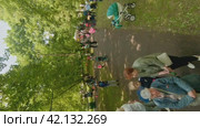 Cherepovets, Russia - May 27, 2023, Little Explorers, Big Adventures, Family Time in the Green Outdoors. FPV Aerial Drone Shot. Vertical. Редакционное видео, видеограф Даниил Хабаров / Фотобанк Лори