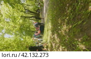 Cherepovets, Russia - May 27, 2023, Cheerful Children and Parents, Leisure and Laughter in the Park. FPV Aerial Drone Shot. Vertical. Редакционное видео, видеограф Даниил Хабаров / Фотобанк Лори