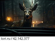 View from the inside of a car, deer standing in the middle of the road, illuminated by the car headlights. Danger of hitting deer with a car. Стоковое AI-изображение, AI-художник Ирина Михайличенко / Фотобанк Лори