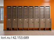 Orange steel Mailboxes in an apartment residential building inside. Modern rows of numbered mailbox, creative design mail backgrounds. Urban correspondence concept. Copy ad text space. Generated Ai. Стоковое AI-изображение, AI-художник Aleksandr Golubev / Фотобанк Лори