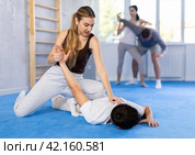 Couples self-defense training - a woman learns to seize power against male attacker. Стоковое фото, фотограф Яков Филимонов / Фотобанк Лори