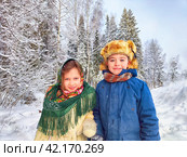 Two cute happy little cheerful children in winter snow forest. Photo shoot in stylized clothes of USSR. Fur Hat with earflaps. Стоковое фото, фотограф Кривошеина Елена Леонидовна / Фотобанк Лори