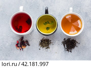 Cups with different tea Red, green and black on grey table. Стоковое фото, фотограф Глущенко Елена / Фотобанк Лори