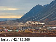Industrial Arctic landscape. View of the industrial area in the tundra. Fuming chimneys of a power plant. Industry and ecology of the polar region. Ozyorny, Egvekinot, Chukotka, Far North of Russia. Стоковое фото, фотограф Андрей Степанов / Фотобанк Лори