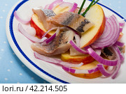 Slices of mild-cured herring with fried potatoes and onions served. Стоковое фото, фотограф Яков Филимонов / Фотобанк Лори