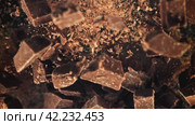Chunks of chocolate fly up and fall down. Filmed on a high-speed camera at 1000 fps. Стоковое видео, видеограф Артем Шадрин / Фотобанк Лори