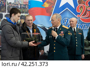 Генеральный директор 345 Механического завода Рустам Мухтарович Гатауллин вручает подарок молодому человеку (2024 год). Редакционное фото, фотограф Дмитрий Неумоин / Фотобанк Лори