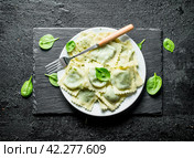 Ravioli on a plate with a fork. Стоковое фото, фотограф Артем Шадрин / Фотобанк Лори