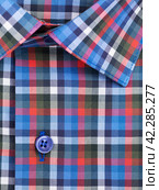 Close-up of a button placket on a multi-colored plaid men's shirt. Стоковое фото, фотограф Сергей Чайко / Фотобанк Лори