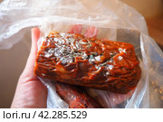 Raw smoked sausage became moldy while it was in a plastic bag. A mold or mould. The dust-like, colored appearance of molds is due to the formation of spores containing fungal secondary metabolites. Стоковое фото, фотограф Юлия Петровская / Фотобанк Лори