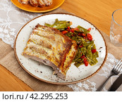 Fried piece of rib bone-in pork garnish with stewed beans and carrot. Стоковое фото, фотограф Яков Филимонов / Фотобанк Лори