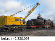 Железнодорожный кран КЖ-462 "Первомаец" загружает углем тендер старого советского паровоза Л-3958 (Лебедянка) на станции Сортавала (2022 год). Редакционное фото, фотограф Виктор Карасев / Фотобанк Лори