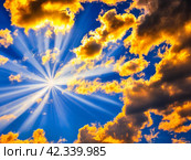 Beautiful sunset sky above clouds with dramatic light. Yellow, orange, red clouds. Beautiful evening sky landscape. Sunset and sunrays. Generated by AI. Divine rays. Стоковое AI-изображение, AI-художник Юлия Петровская / Фотобанк Лори