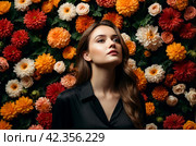 Elegant pensive young lady in black shirt posing at flowers wall background, looking up. Portrait of chic blonde dancer woman with curly hair, thoughtful. Dance psychology concept. Copy ad text space. Стоковое AI-изображение, AI-художник Aleksandr Golubev / Фотобанк Лори