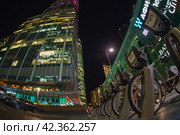 Moscow, Russia - October 1, 2019: Working day had been finished, people leave offices in MIBC (Moscow International Business Center). Workout time. Autumn business concepts. Fish-Eye technique/ lens. Редакционное фото, фотограф YuryKara / Фотобанк Лори